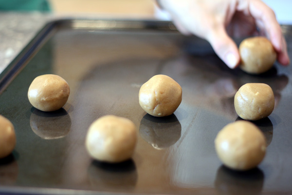 peanut butter cookie balls on baking sheet