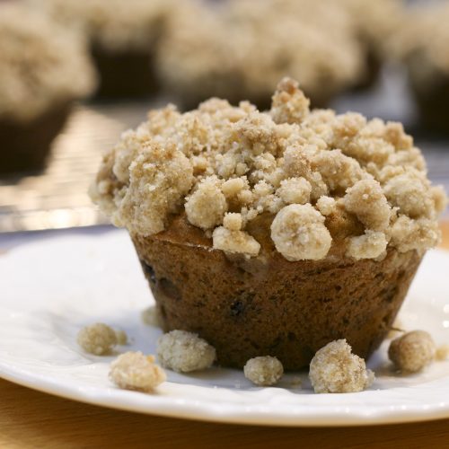 banana muffin with streusel crumb topping on a plate