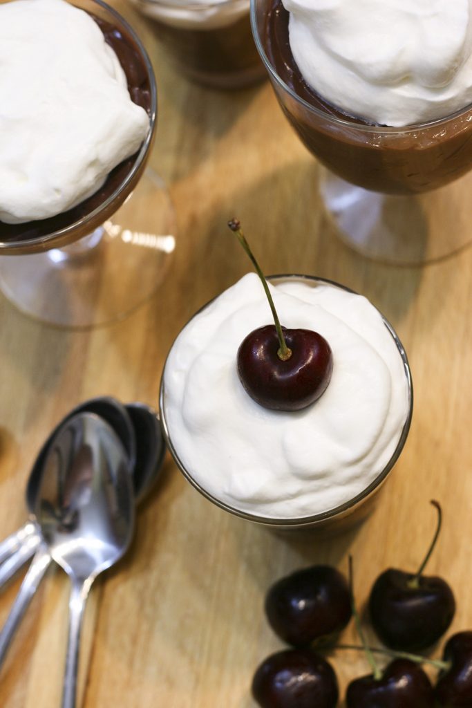 chocolate pudding with whipped cream and cherry on top